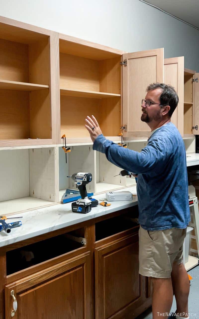 man installing garage cabinets