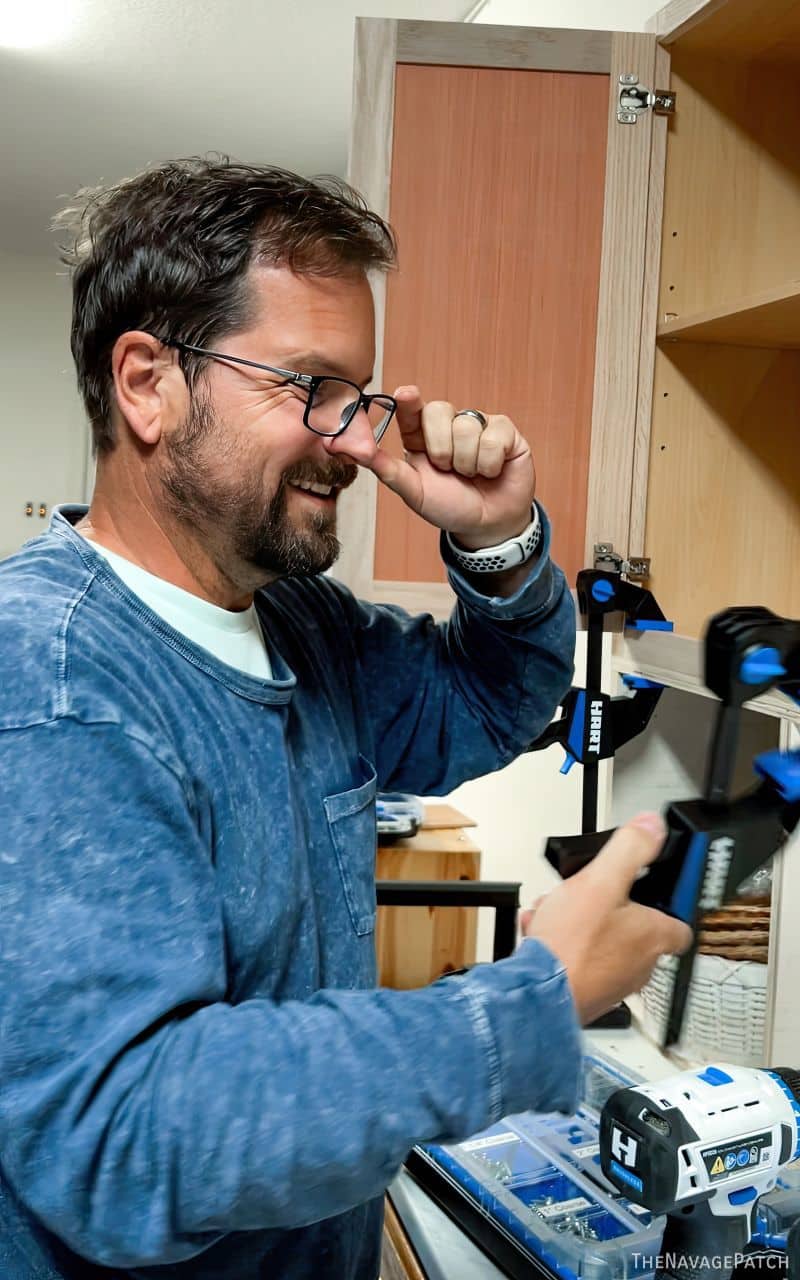 man smiling at his new cabinets