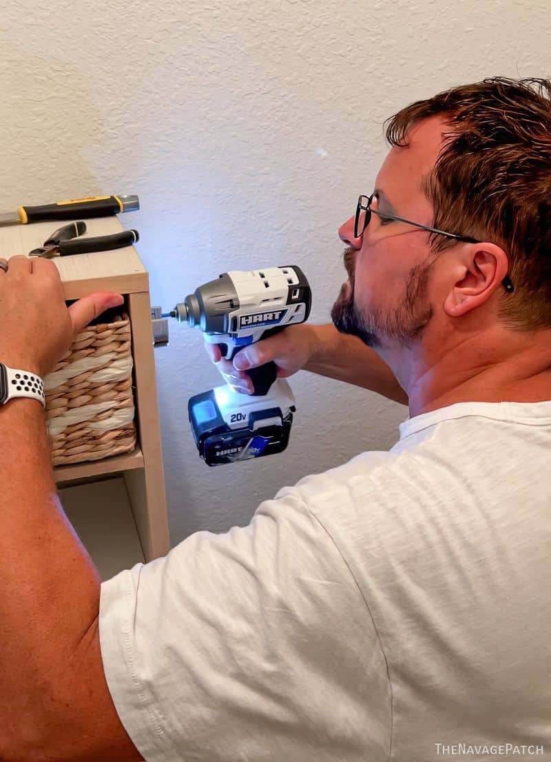 man installing a custom closet system