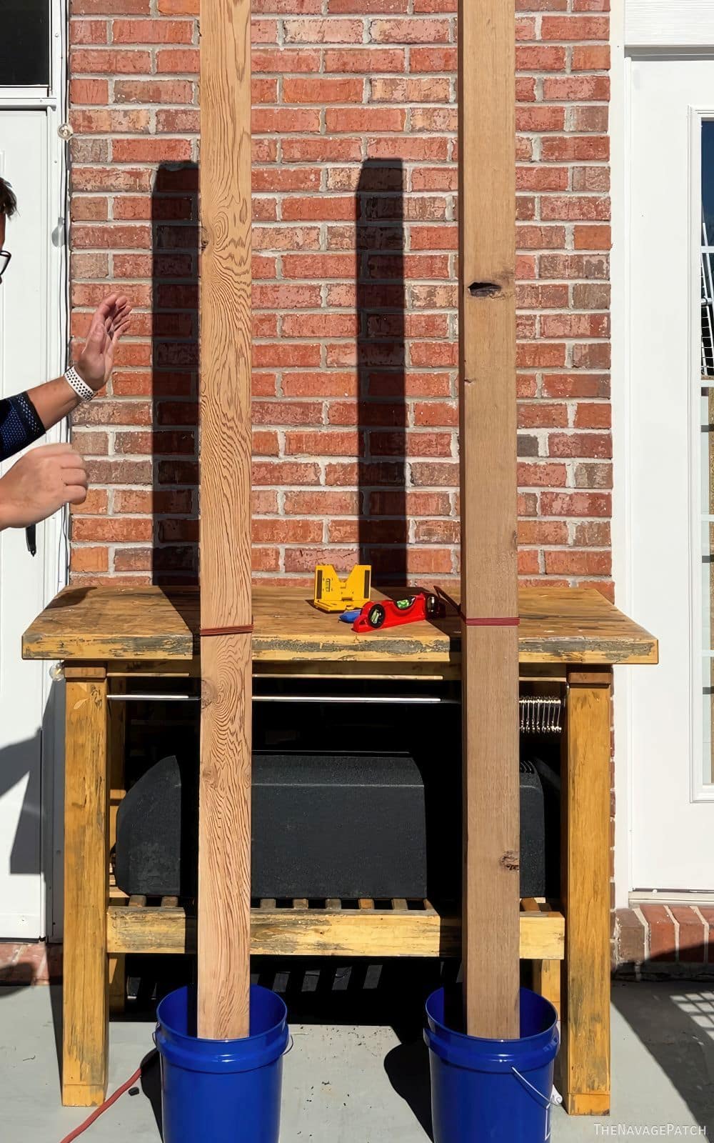 two cedar posts standing in 2 buckets