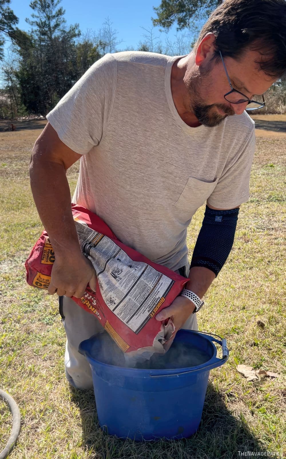 man mixing concrete in a bucket