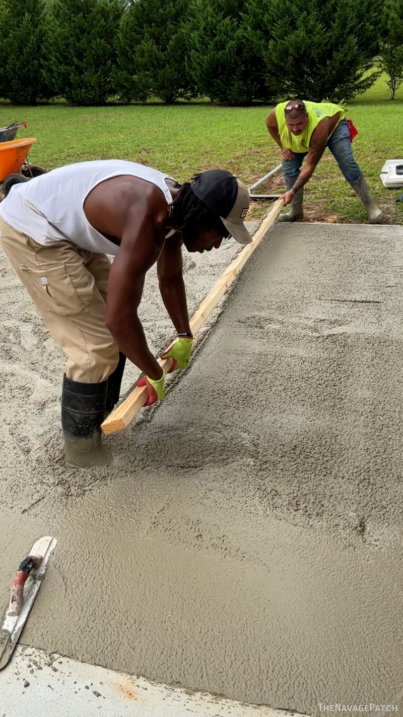 men pouring a concrete patio