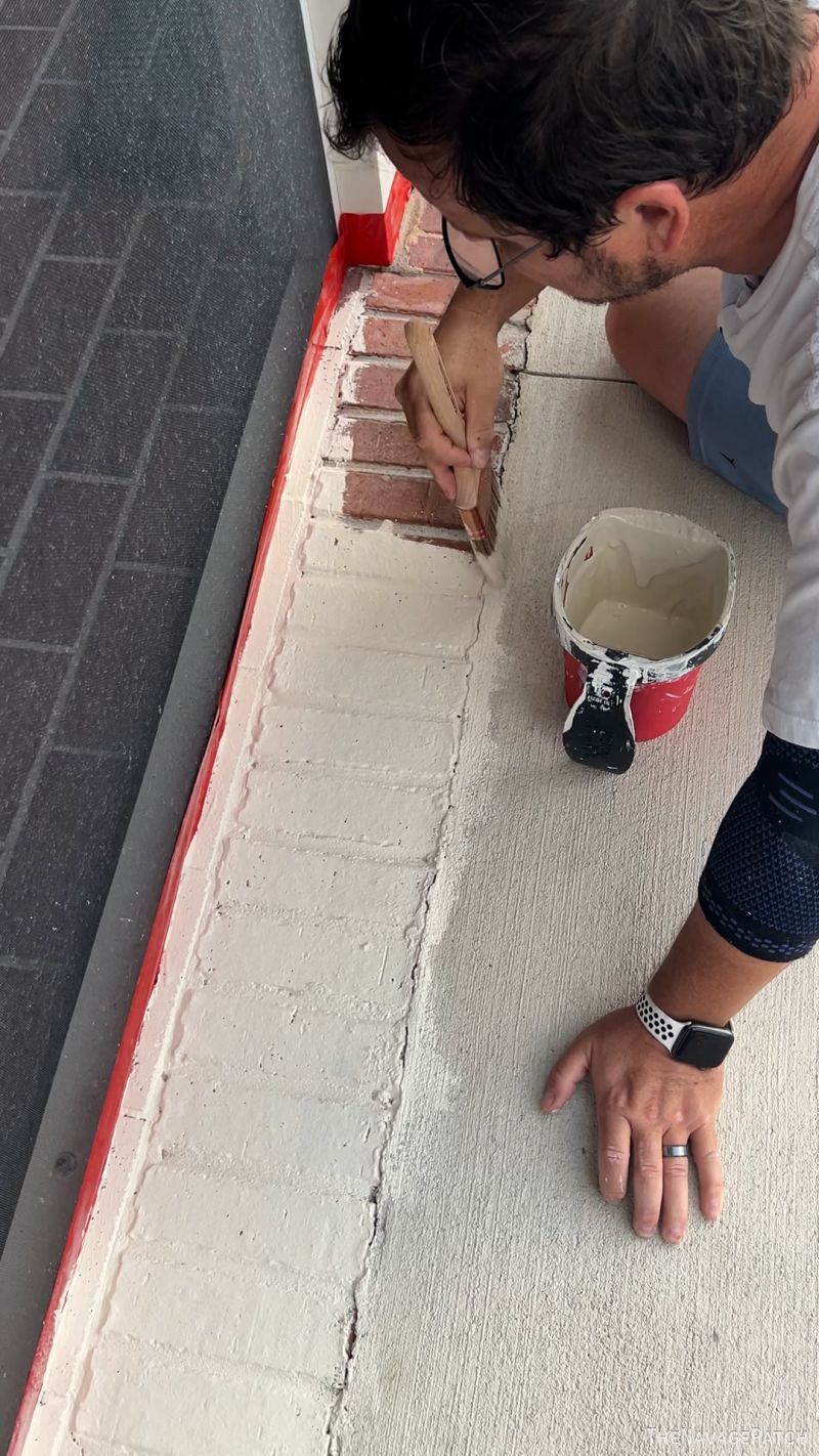 man painting a patio