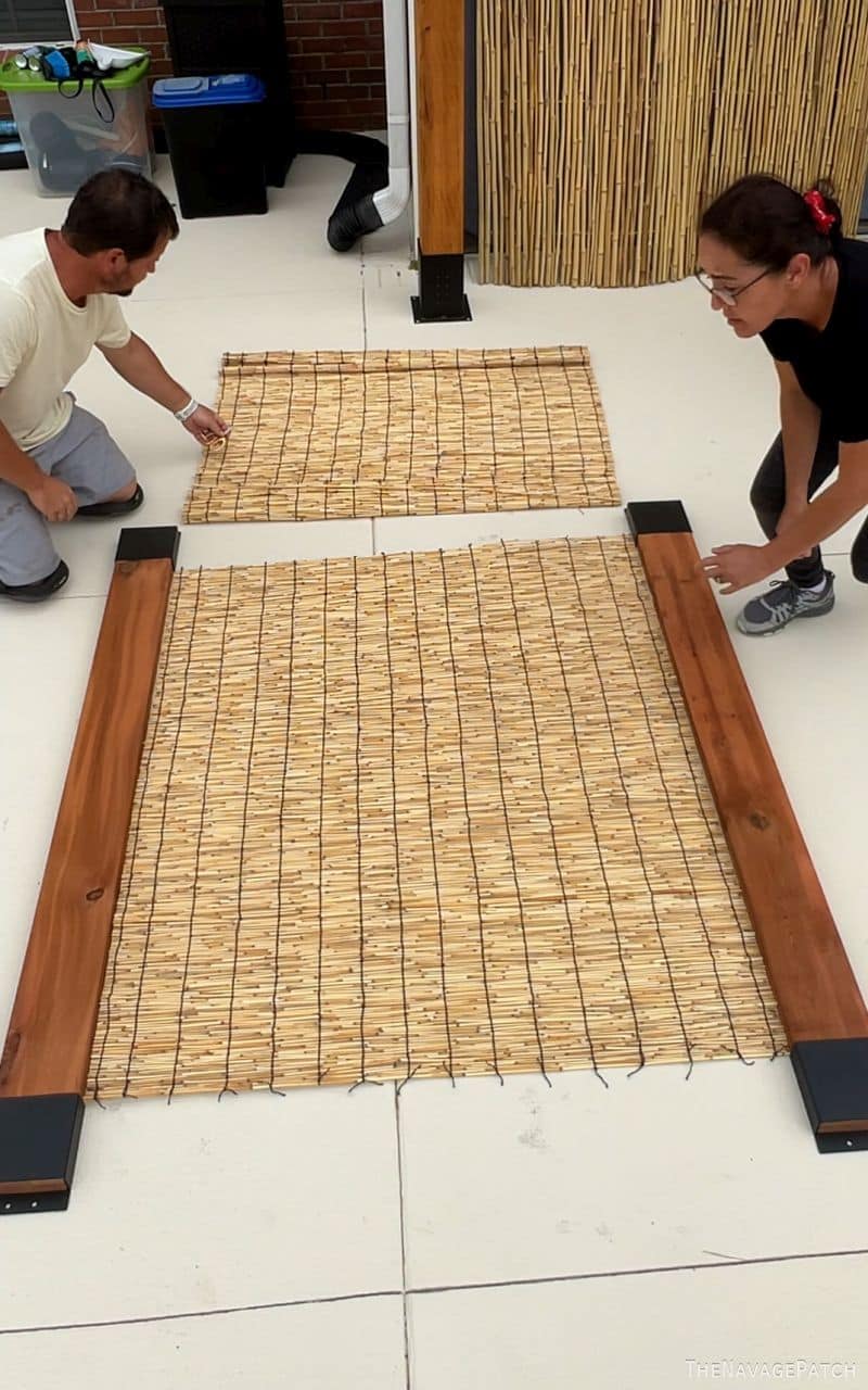 man and wife building a privacy screen