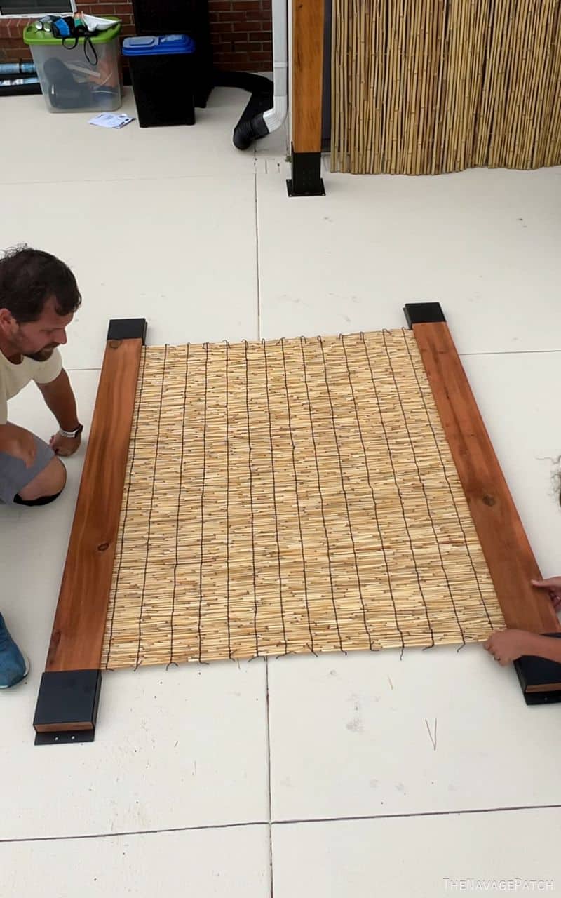 man and wife building a privacy screen