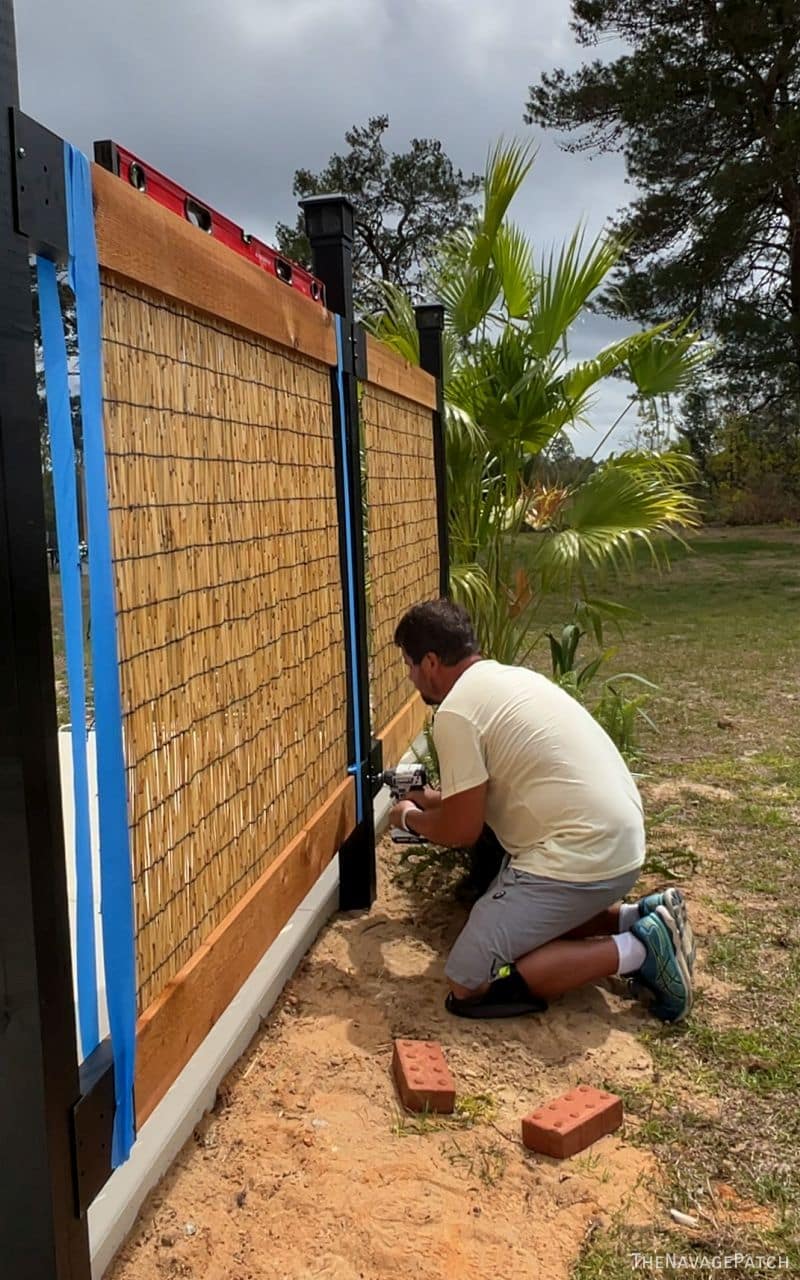 man and wife building a privacy screen