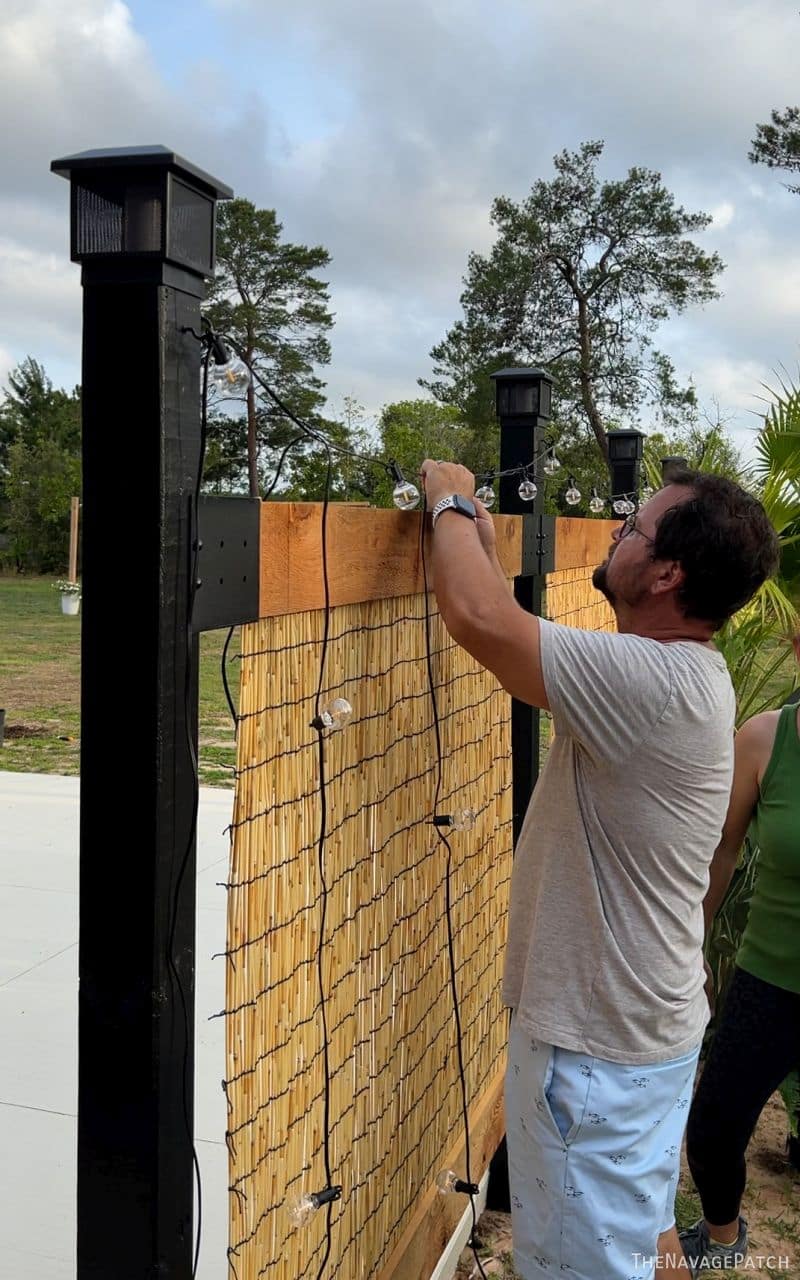 man and wife building a privacy screen
