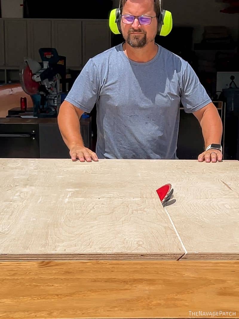 man cutting plywood