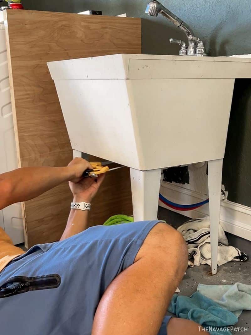 man removing a sink