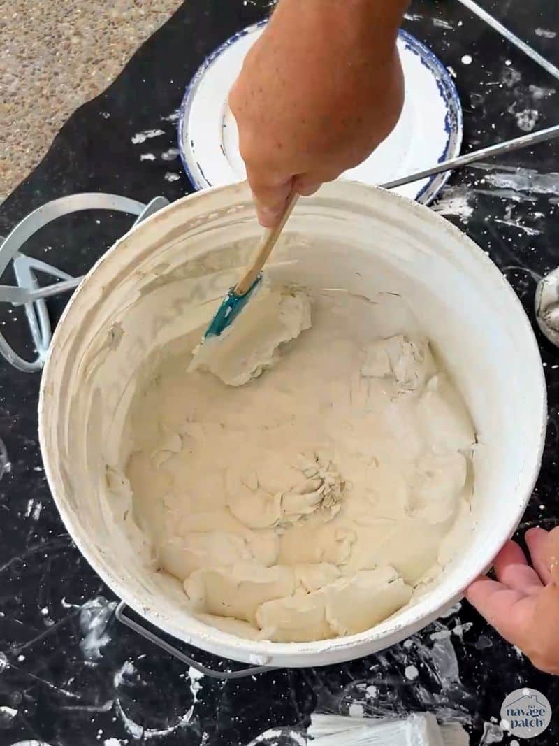 man mixing limewash paint