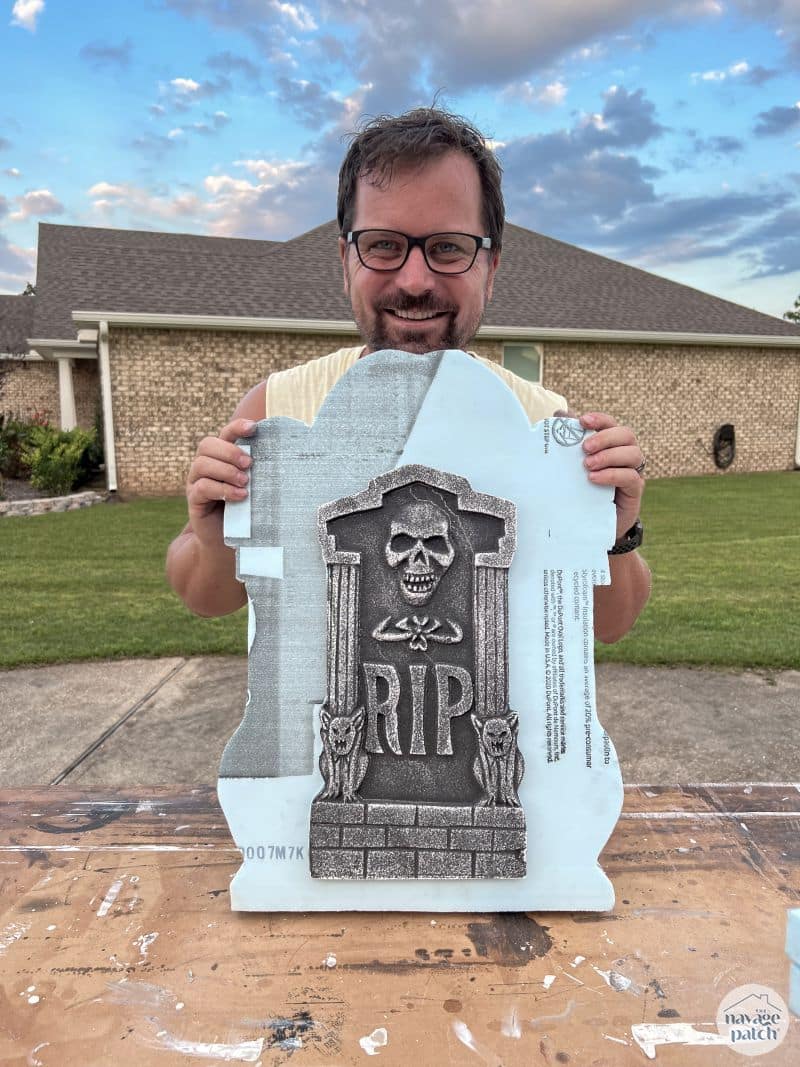 man holding diy tombstone