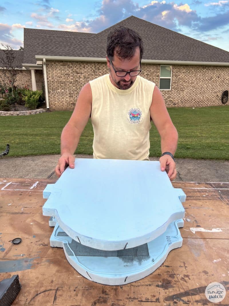 man gluing two pieces of foam together