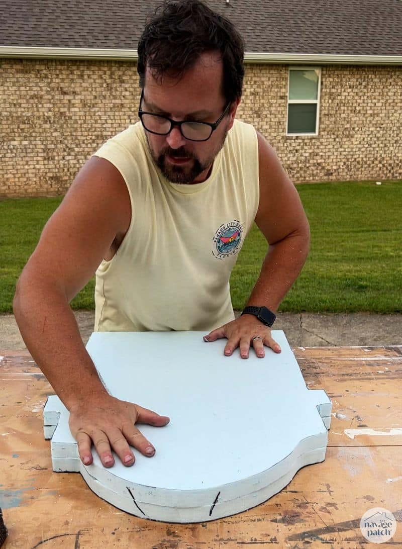 man gluing two pieces of foam together