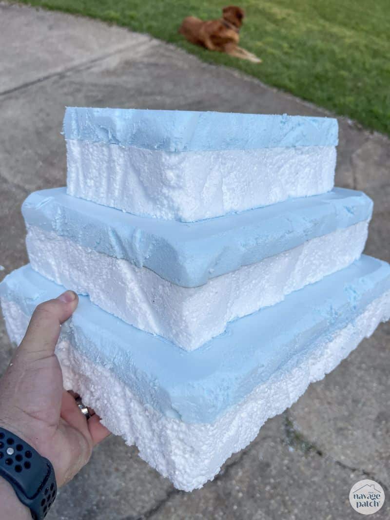 man holding tiered foam