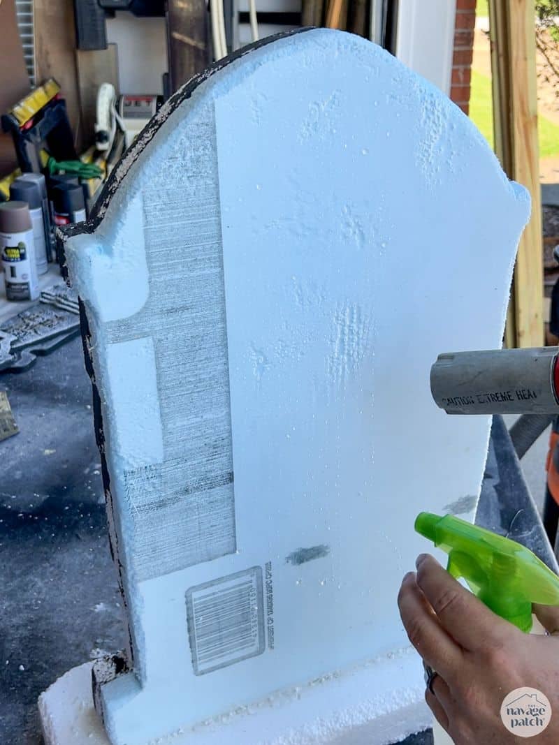 man weathering a tombstone