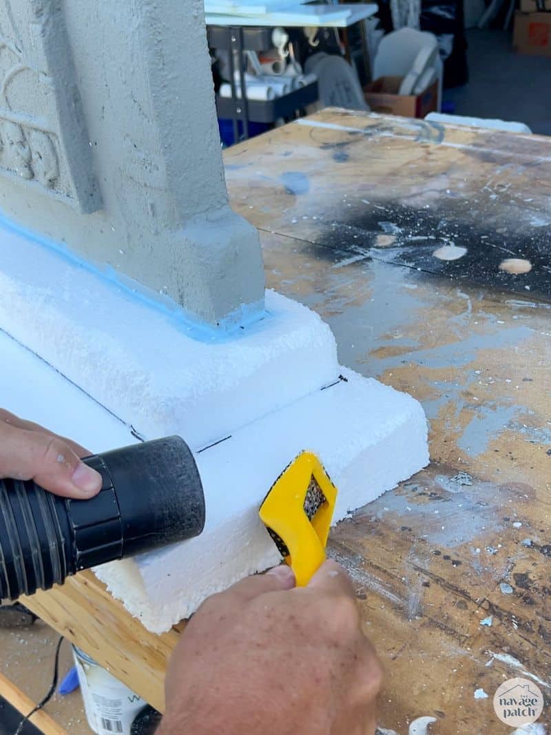 man using surform tool to age headstones