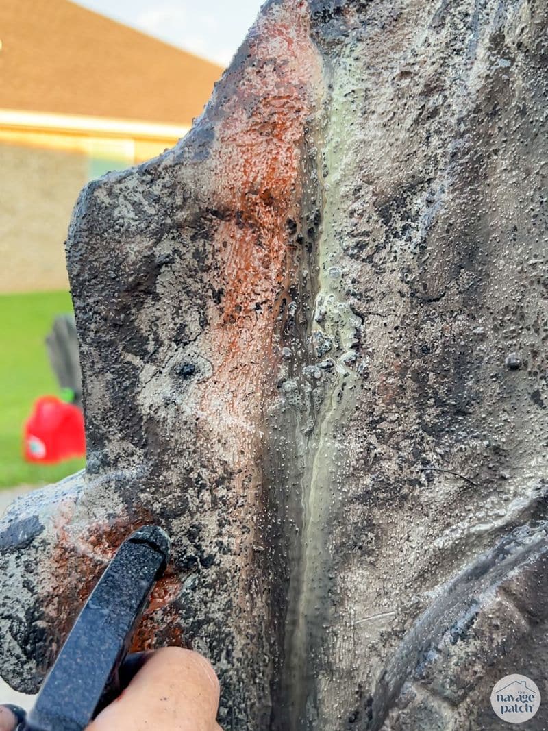 man painting tombstone