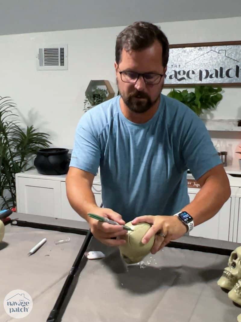 man marking a plastic skull