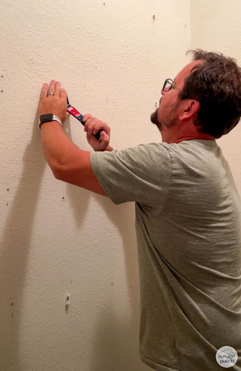 man removing wire closet shelves