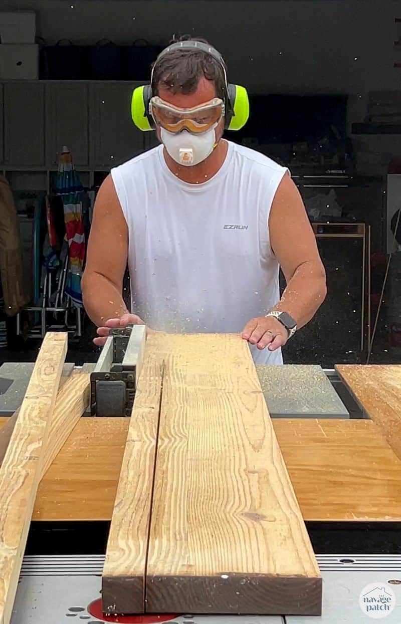 man cutting shelf supports from lumber