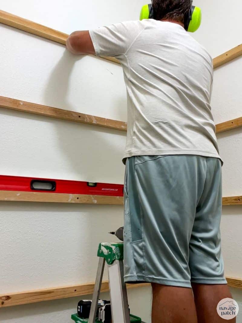 man installing shelf supports