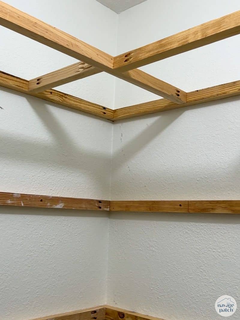 man building shelves in a closet