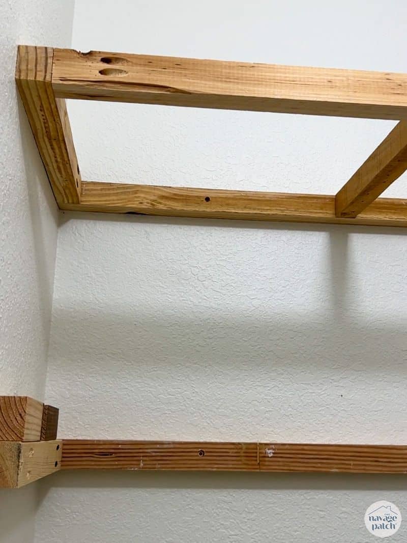 man building shelves in a closet