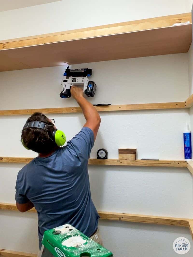 man making closet shelves