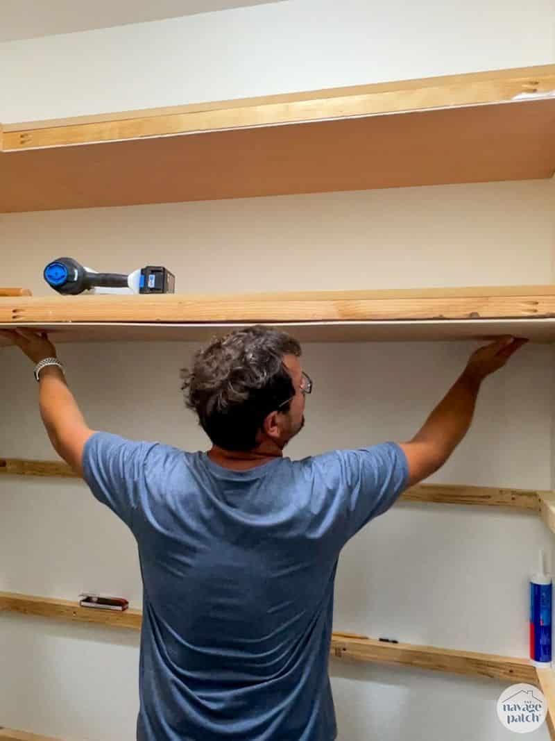 man making closet shelves