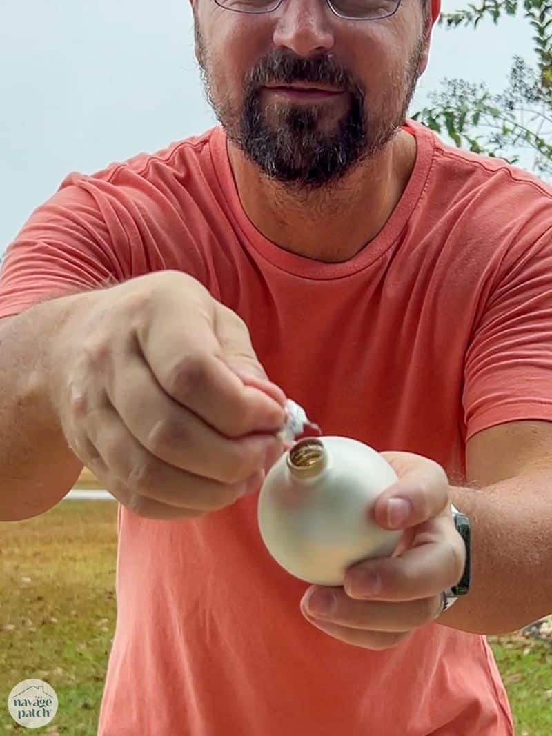 man pulling ornament pin