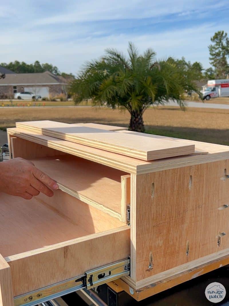 man making a small cubby cabinet