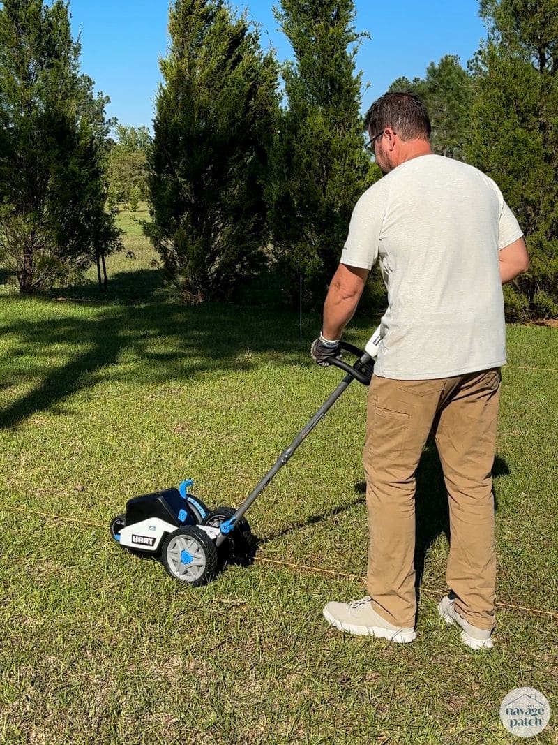 man using an edger on grass