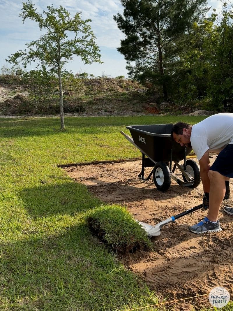 man removing sod from his yard