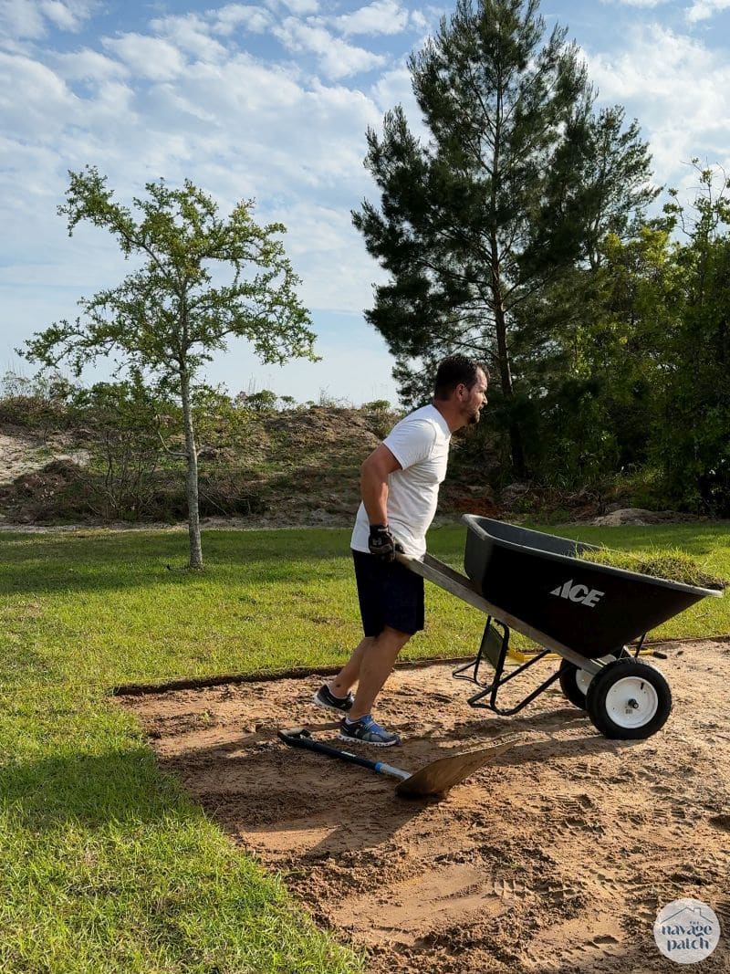 man removing sod from his yard