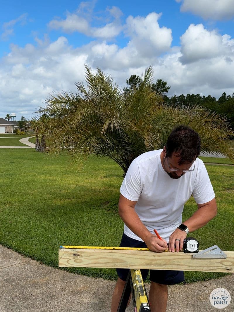 man cutting 4x4 post