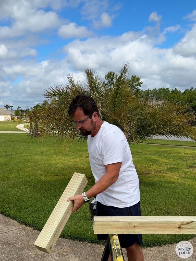 man cutting 4x4 post