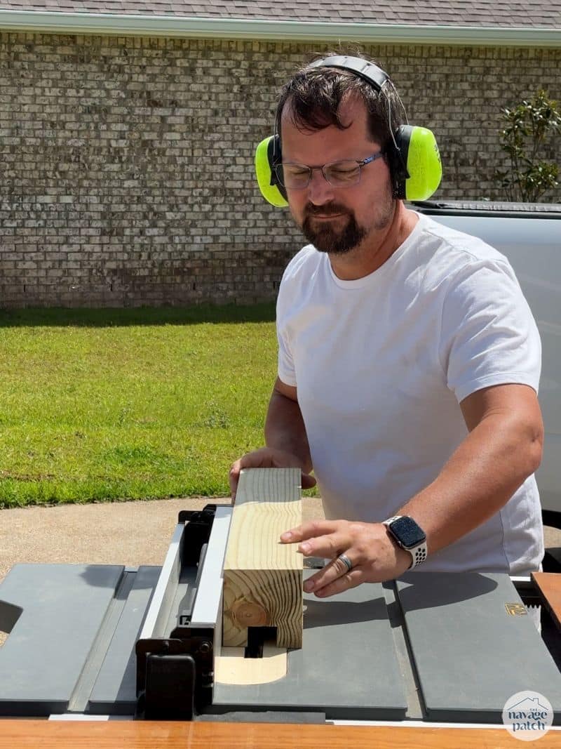 man cutting 4x4 post