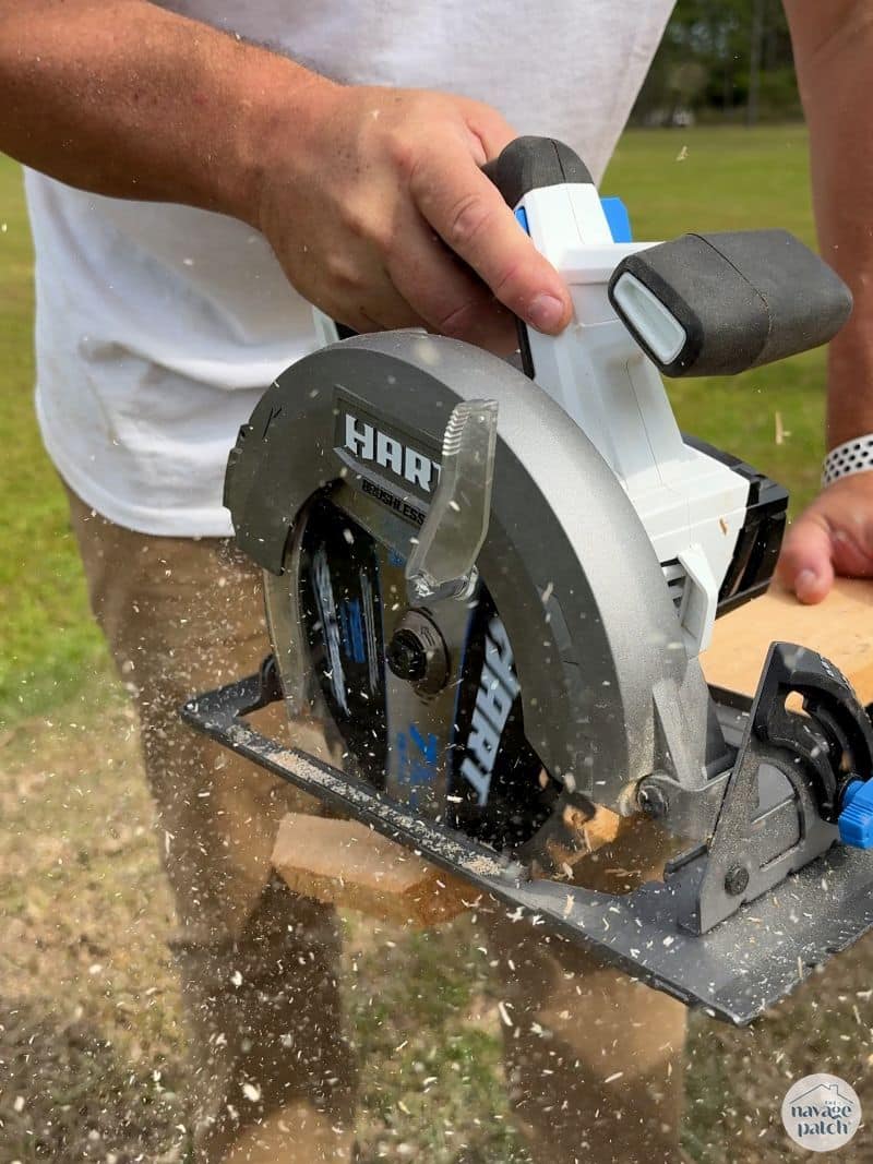 man cutting fence pickets