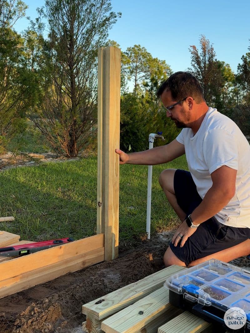 man building a diy raised garden bed