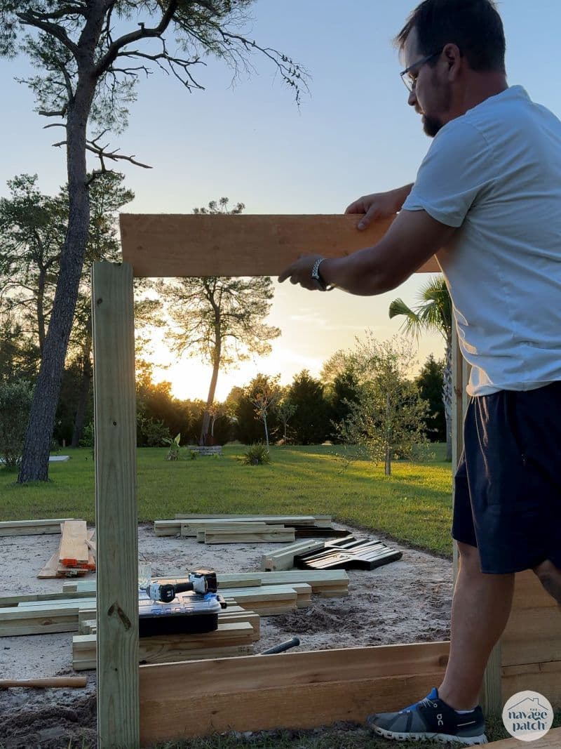 man building a diy raised garden bed