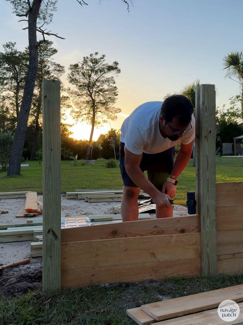 man building a diy raised garden bed