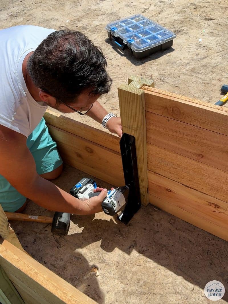 man building a diy raised garden bed