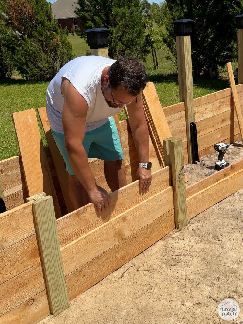 man building a diy raised garden bed