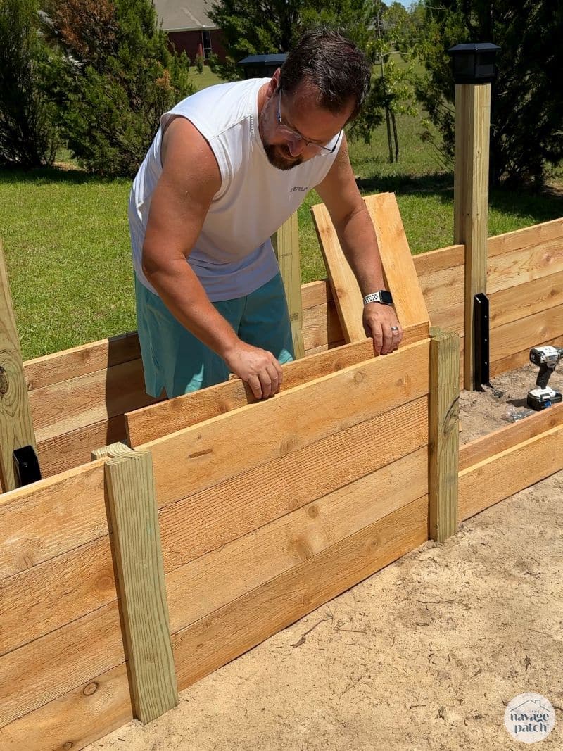man building a diy raised garden bed