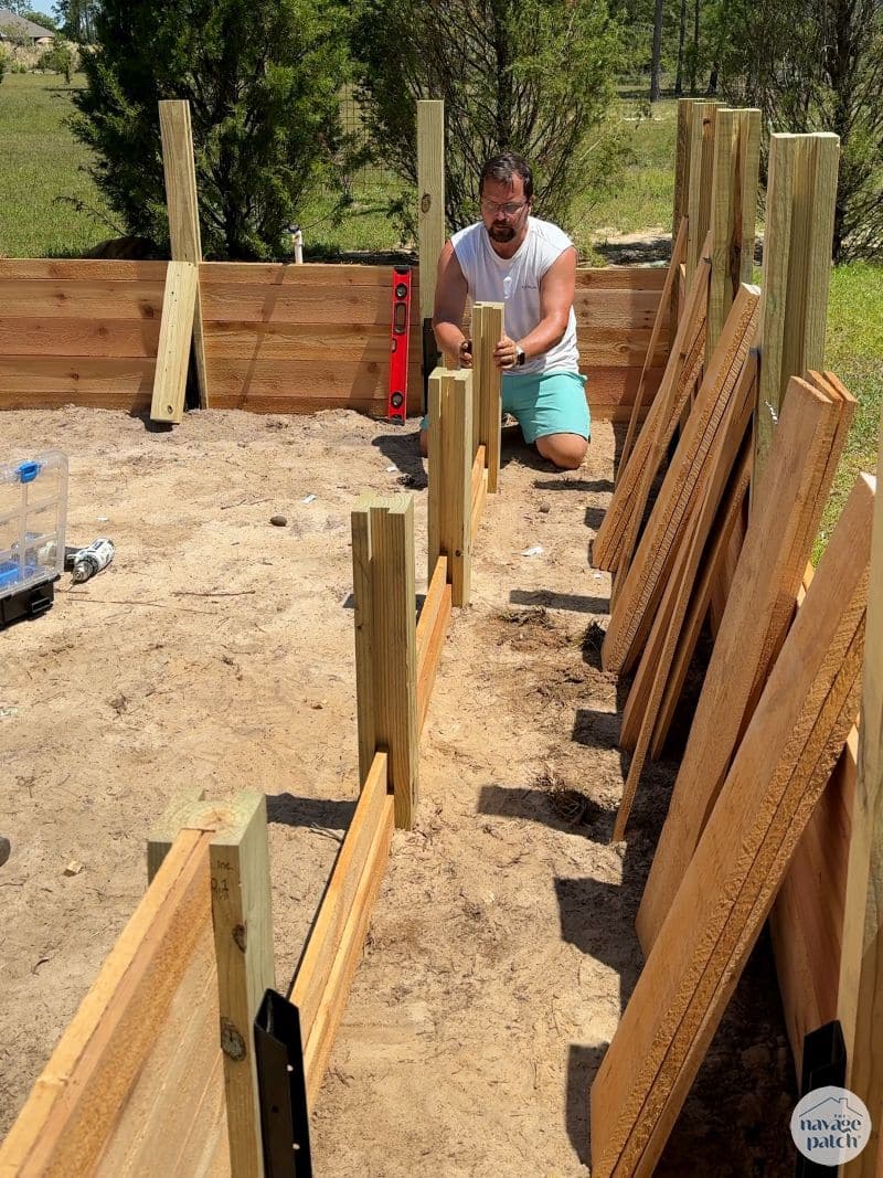 man building a diy raised garden bed