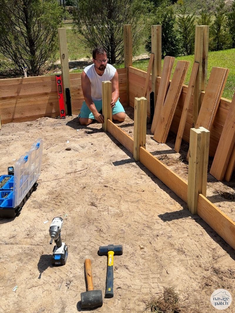 man building a diy raised garden bed