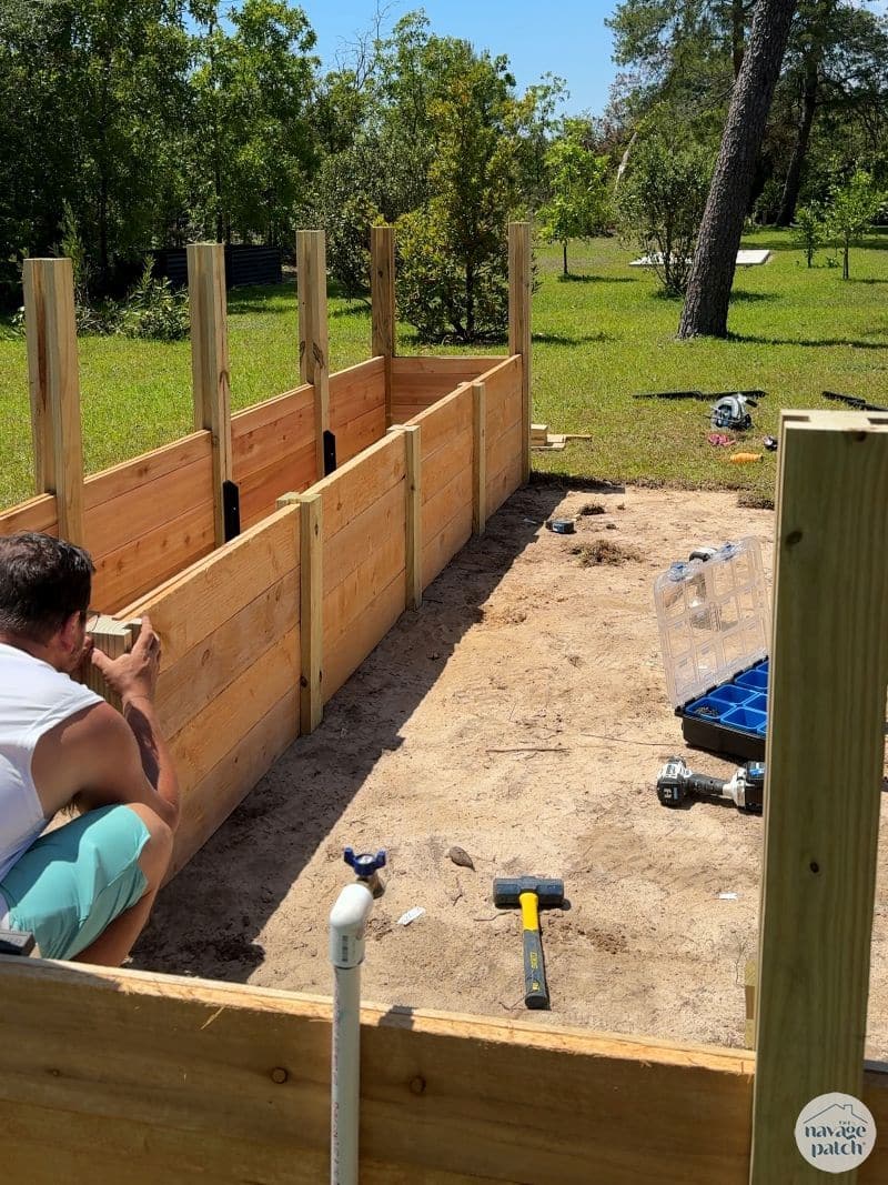 man building a diy raised garden bed