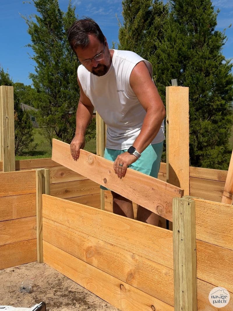 man building a diy raised garden bed