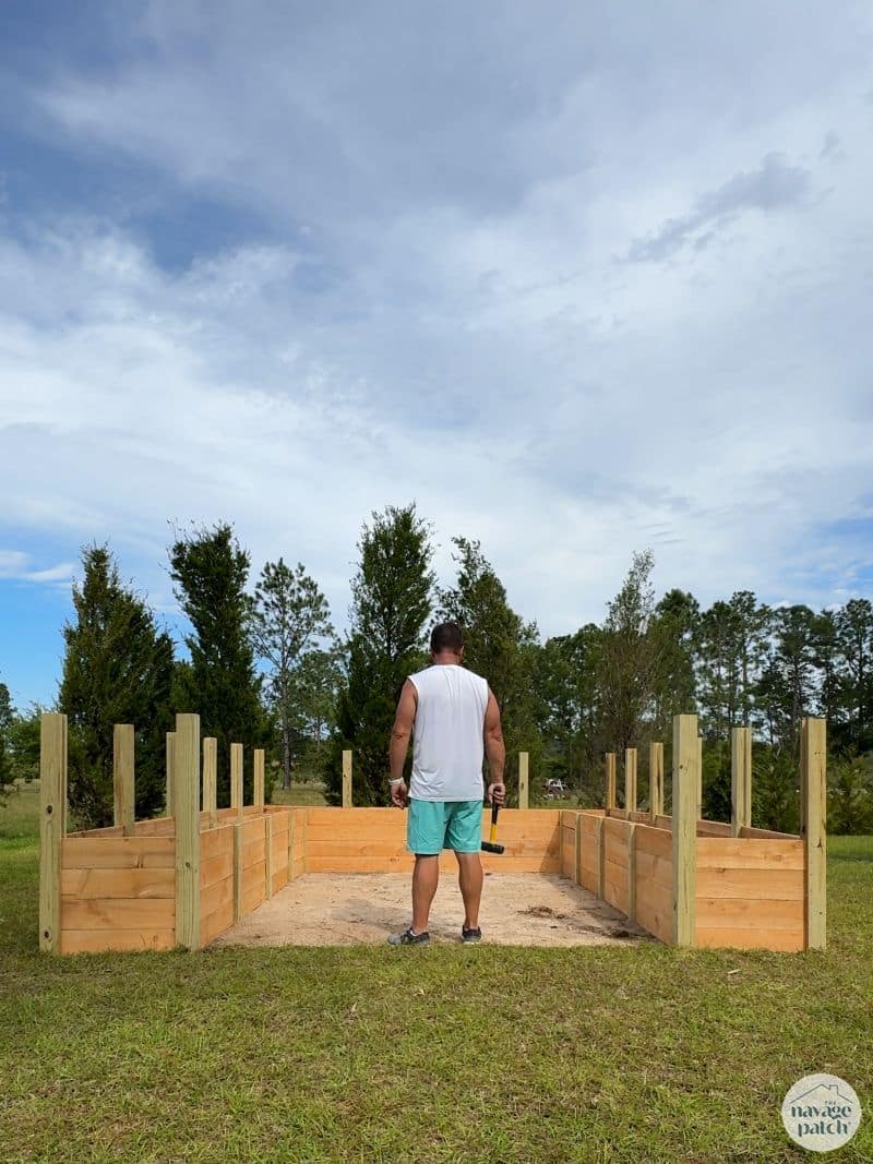 man building a diy raised garden bed