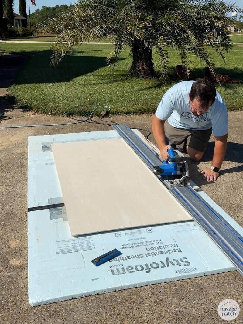 man cutting plywood with a plunge saw